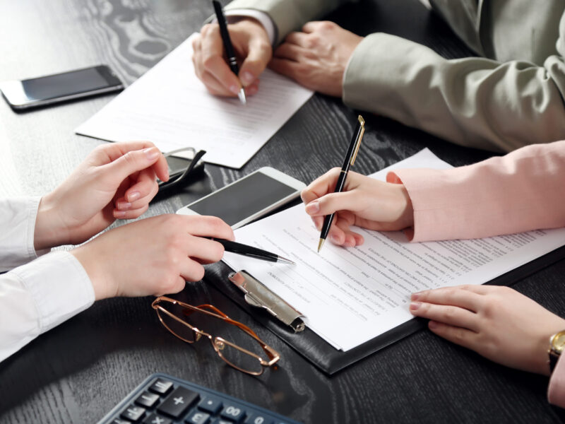 Human,Hands,Working,With,Documents,At,The,Desk,Closeup
