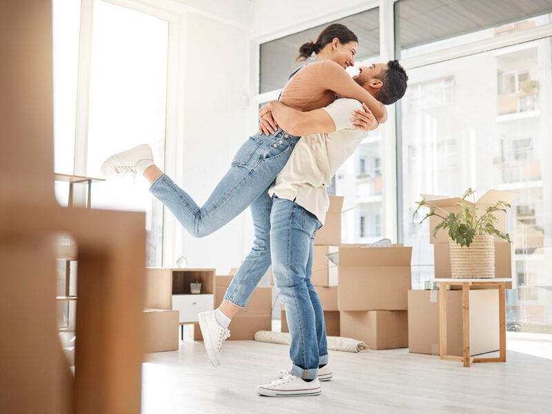 Love, moving and hug with couple in new home for celebration, property and relocation. Excited, happy and real estate with man and woman in living room apartment for investment, rent and homeowner.
